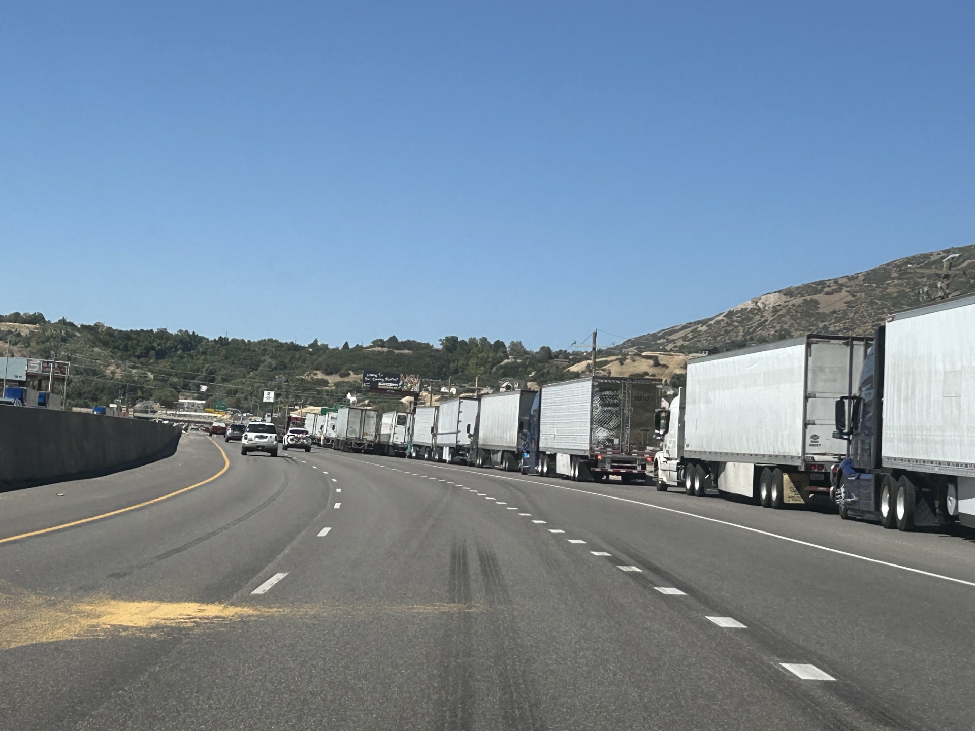 A long line of trucks waits on the side of the road before the turnoff for I-84 off of U.S. 89 near South Weber while crews fight the Broad Fire on Saturday.