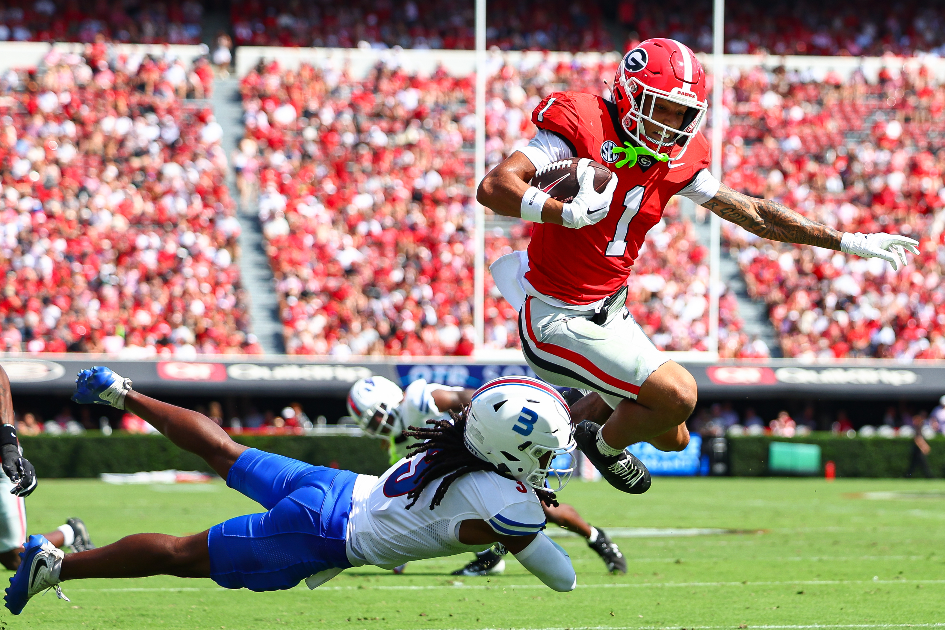 Georgia wide receiver Talyn Taylor (1) hurdles Tennessee State defensive back Mikeece Jones (3) before scoring a touchdown during the first half of an NCAA college football game, Saturday, Sept. 5, 2026, in Athens, Ga. 