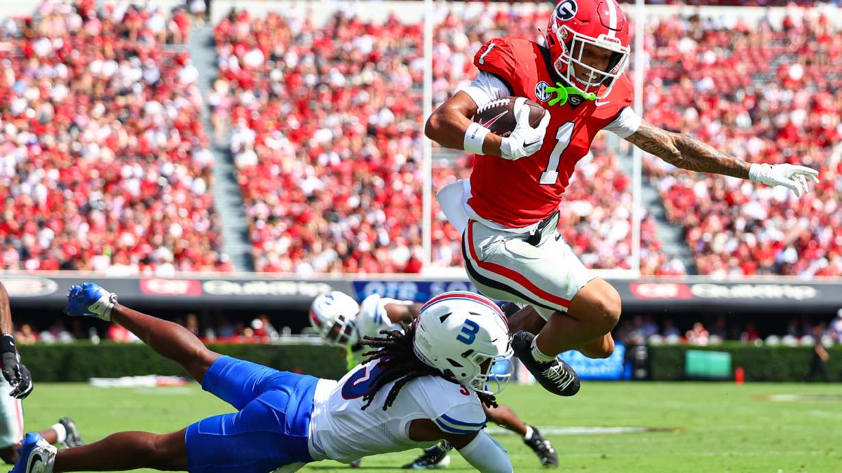 Georgia wide receiver Talyn Taylor (1) hurdles Tennessee State defensive back Mikeece Jones (3) before scoring a touchdown during the first half of an NCAA college football game, Saturday, Sept. 5, 2026, in Athens, Ga.