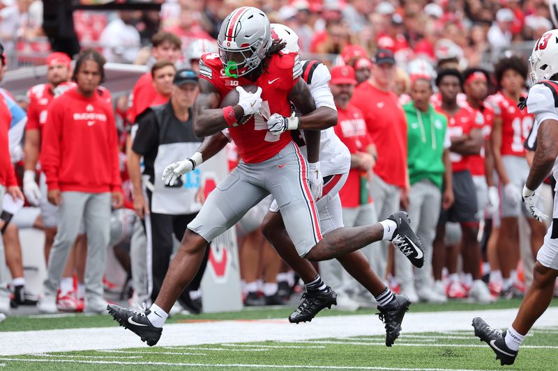 Sep 5, 2026; Columbus, Ohio, USA;  Ohio State Buckeyes wide receiver Jeremiah Smith (4) runs after a catch during the second quarter against the Ball State Cardinals at Ohio Stadium.