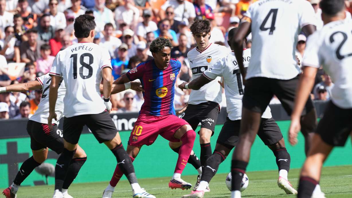 Barcelona's Lamine Yamal fights for the ball during a Spanish La Liga soccer match between Valencia and Barcelona in Valencia, Spain, Sunday, Sept. 6, 2026.