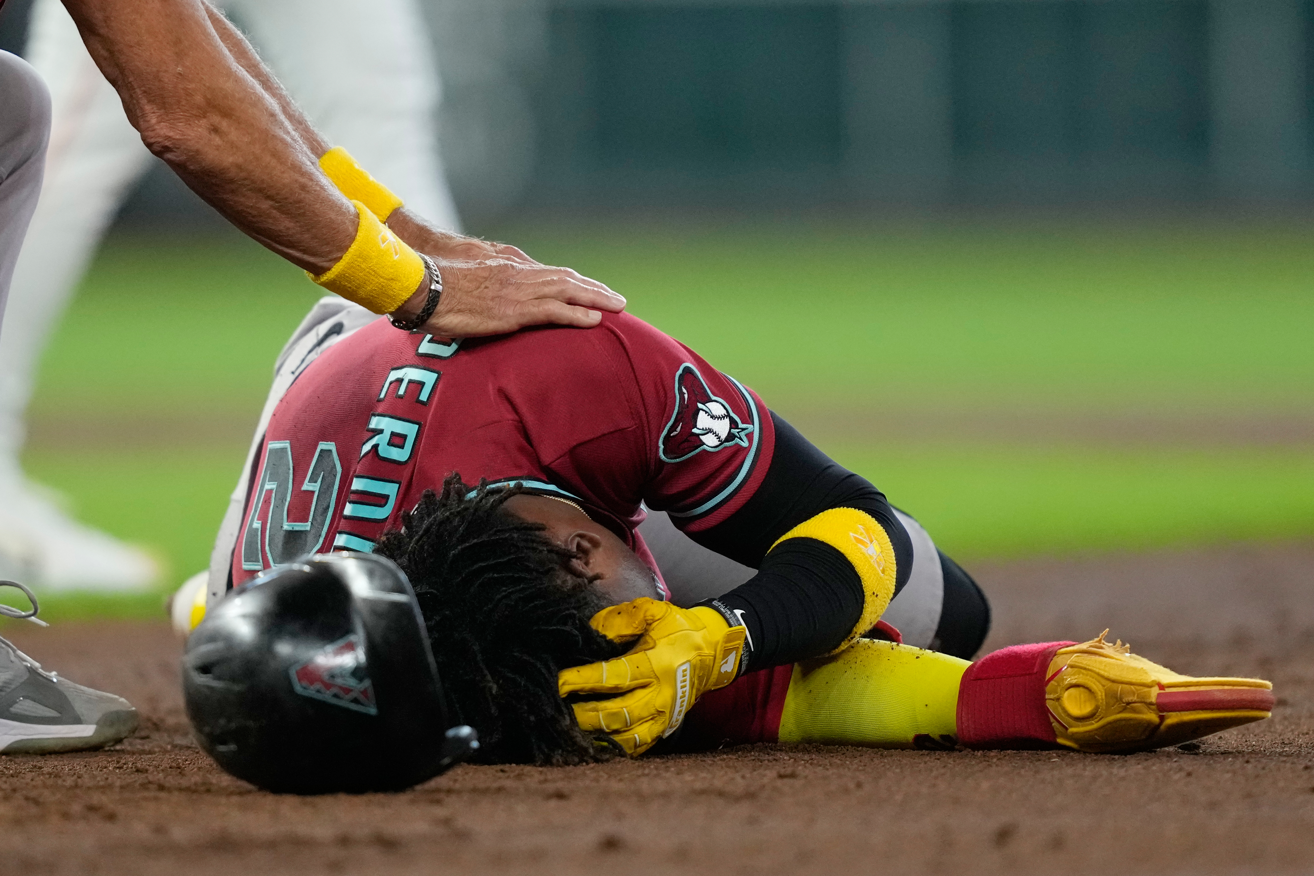 Arizona Diamondbacks' Geraldo Perdomo (2) holds his head after being hit by a line drive by Ketel Marte during the third inning of a baseball game against the Houston Astros Sunday, Sept. 6, 2026, in Houston. 