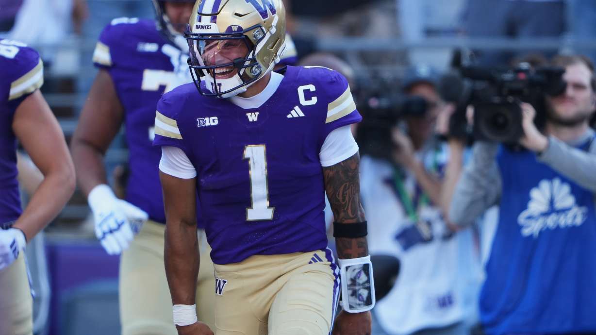 Washington quarterback Demond Williams Jr. celebrates scoring a touchdown against Washington State during the first half of an NCAA college football game, Sunday, Sept. 6, 2026, in Seattle.