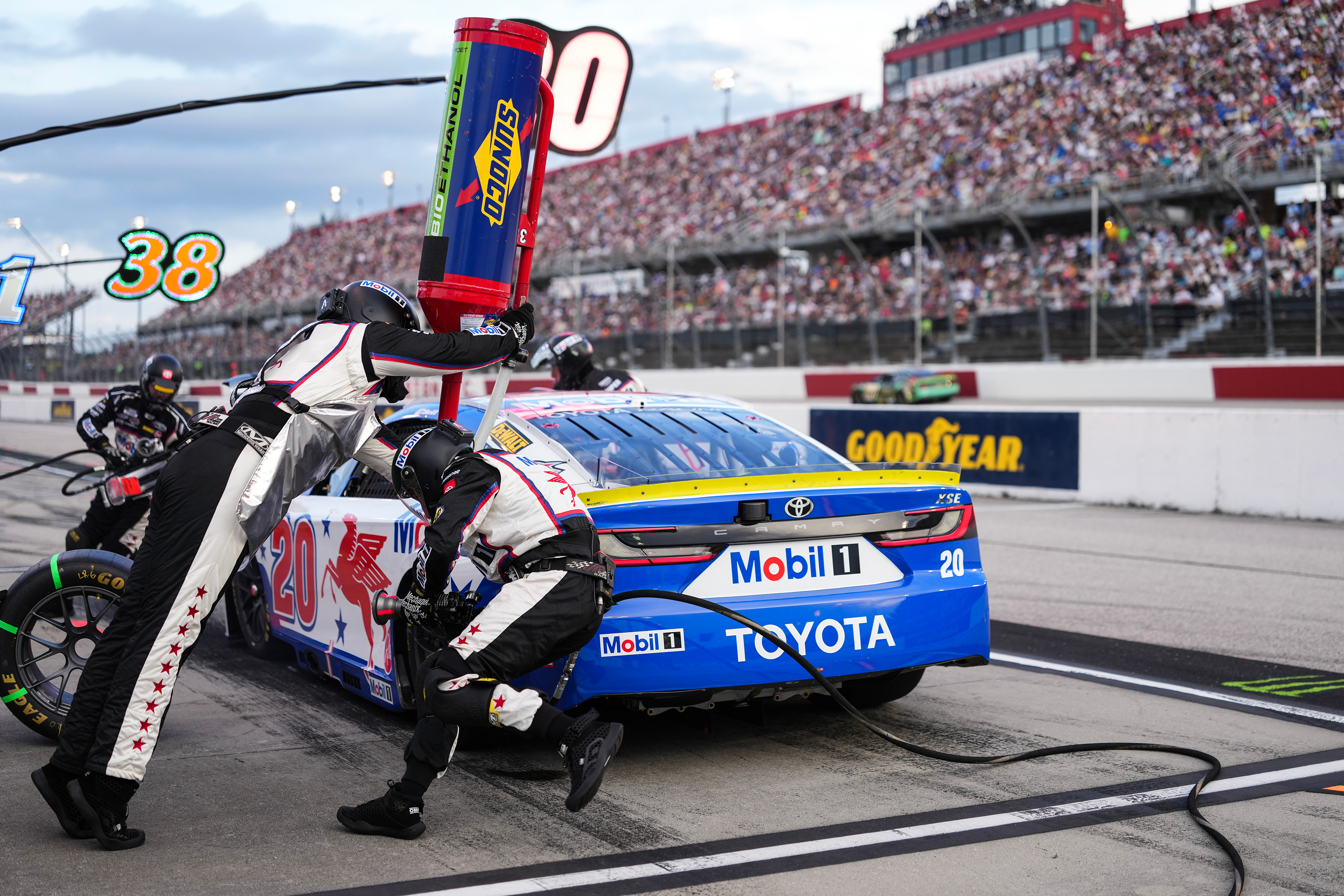 The pit crew for Christopher Bell rushes to complete a pit stop during a NASCAR Cup Series auto race at Darlington Raceway, Sunday, Sept. 6, 2026, in Darlington, S.C. 