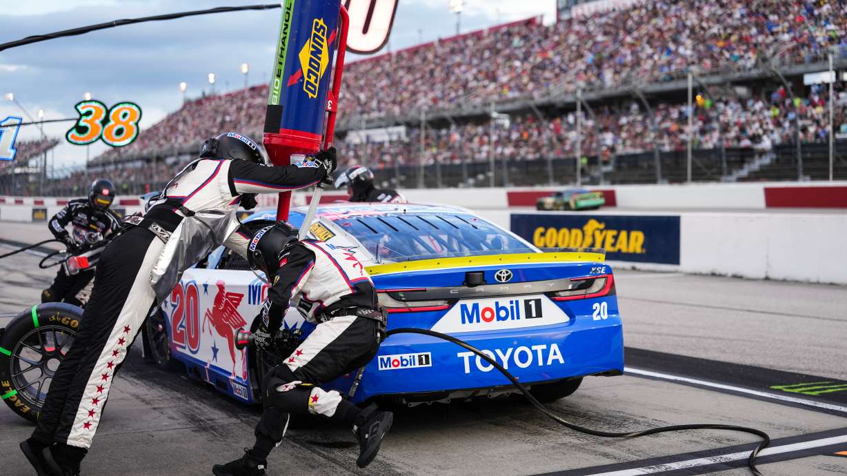 The pit crew for Christopher Bell rushes to complete a pit stop during a NASCAR Cup Series auto race at Darlington Raceway, Sunday, Sept. 6, 2026, in Darlington, S.C.