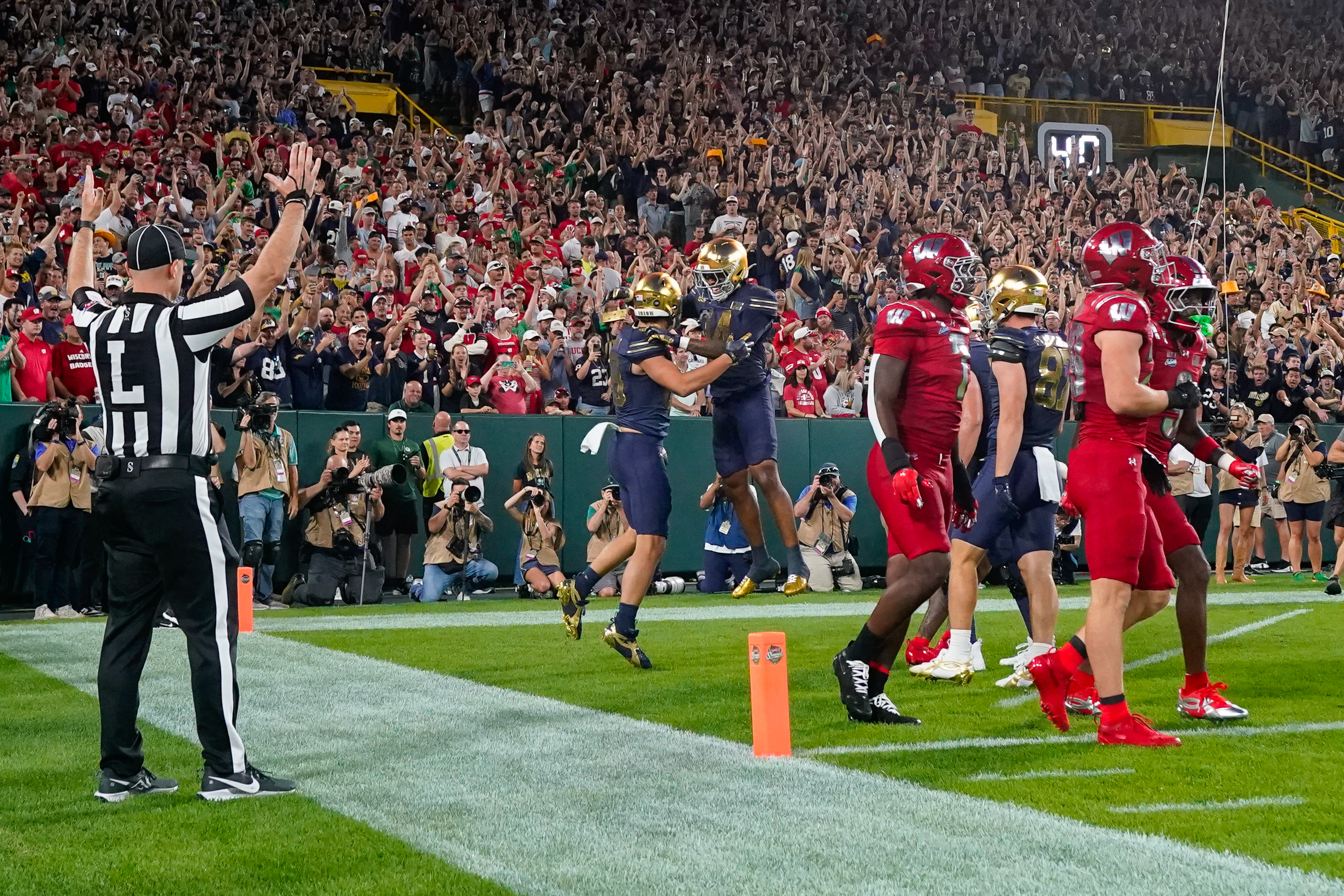 Notre Dame tight end James Flanigan, center left, and teammate Micah Gilbert, center right, celebrate a touchdown during the first half of an NCAA college football game against Wisconsin Sunday, Sept. 6, 2026, in Green Bay, Wis. 