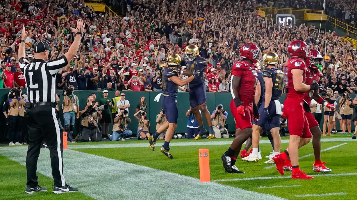 Notre Dame tight end James Flanigan, center left, and teammate Micah Gilbert, center right, celebrate a touchdown during the first half of an NCAA college football game against Wisconsin Sunday, Sept. 6, 2026, in Green Bay, Wis.