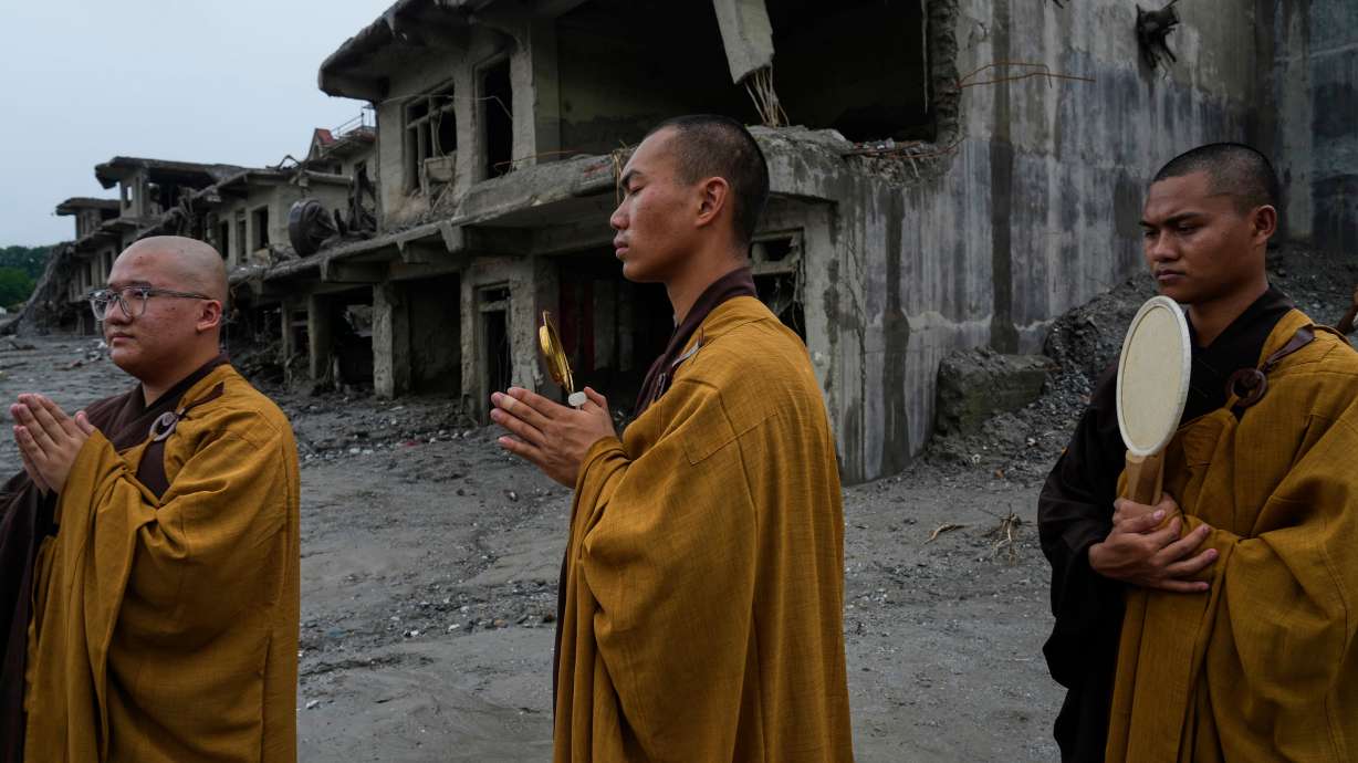 Buddhist monks offer prayers for the departed soul of the victims of flash flood on the bank of Trishuli river in Devighat, Nuwakot district, Nepal, Saturday.