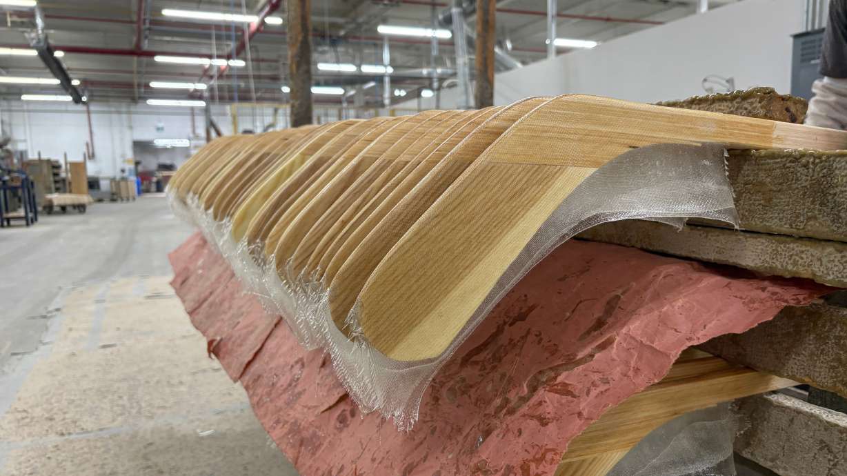 FILE - Wooden hockey sticks are stacked as they move along the assembly line at the Roustan Hockey factory, which is the last major manufacturer of hockey sticks in Canada on Aug. 27, 2025 in Brantford, Ontario.