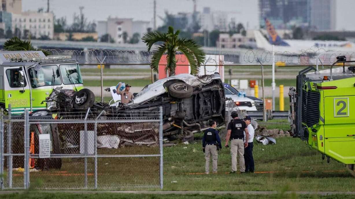 A vehicle lays twisted after an Amazon Air Boeing 767 overshot a runway Sunday at Miami International Airport.