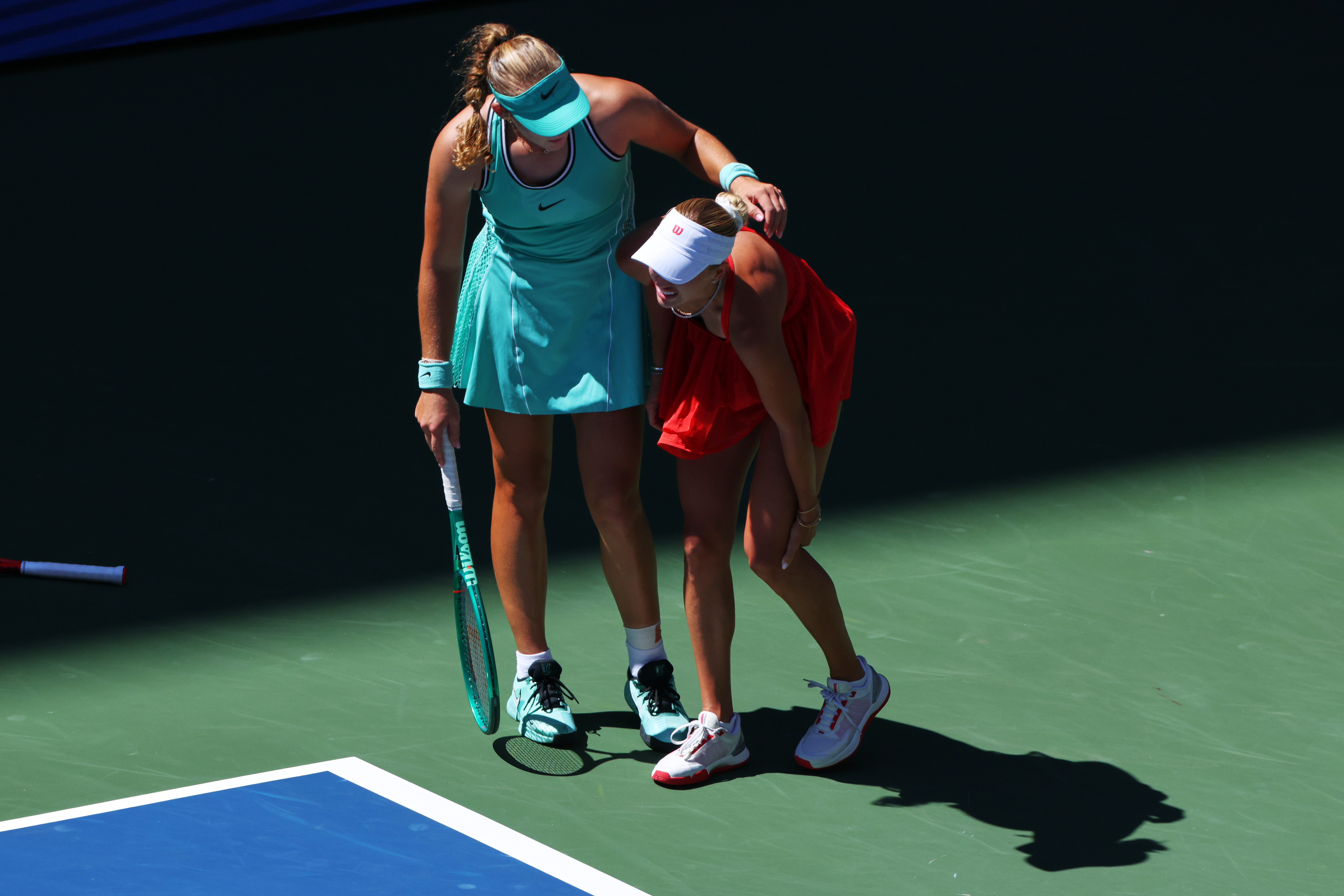 Mirra Andreeva, of Russia, left, helps Anastasia Potapova, of Austria, after Potapova fell during the fourth round of the U.S. Open tennis championships, Monday, Sept. 7, 2026, in New York. 