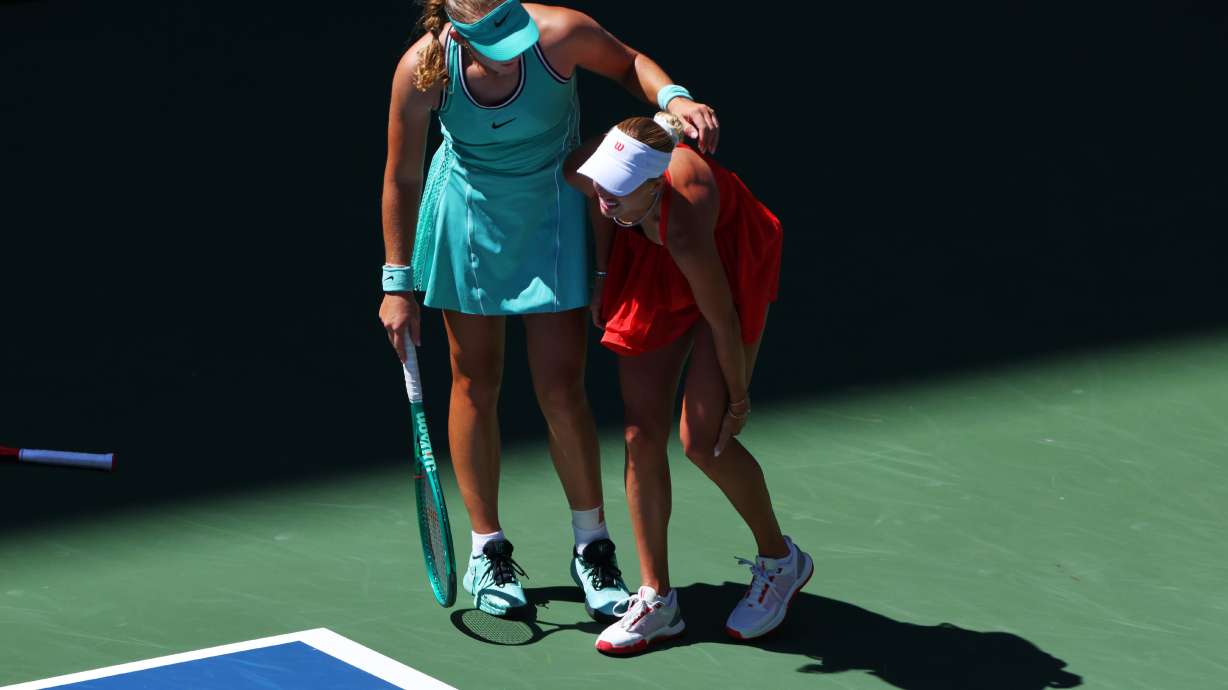 Mirra Andreeva, of Russia, left, helps Anastasia Potapova, of Austria, after Potapova fell during the fourth round of the U.S. Open tennis championships, Monday, Sept. 7, 2026, in New York.