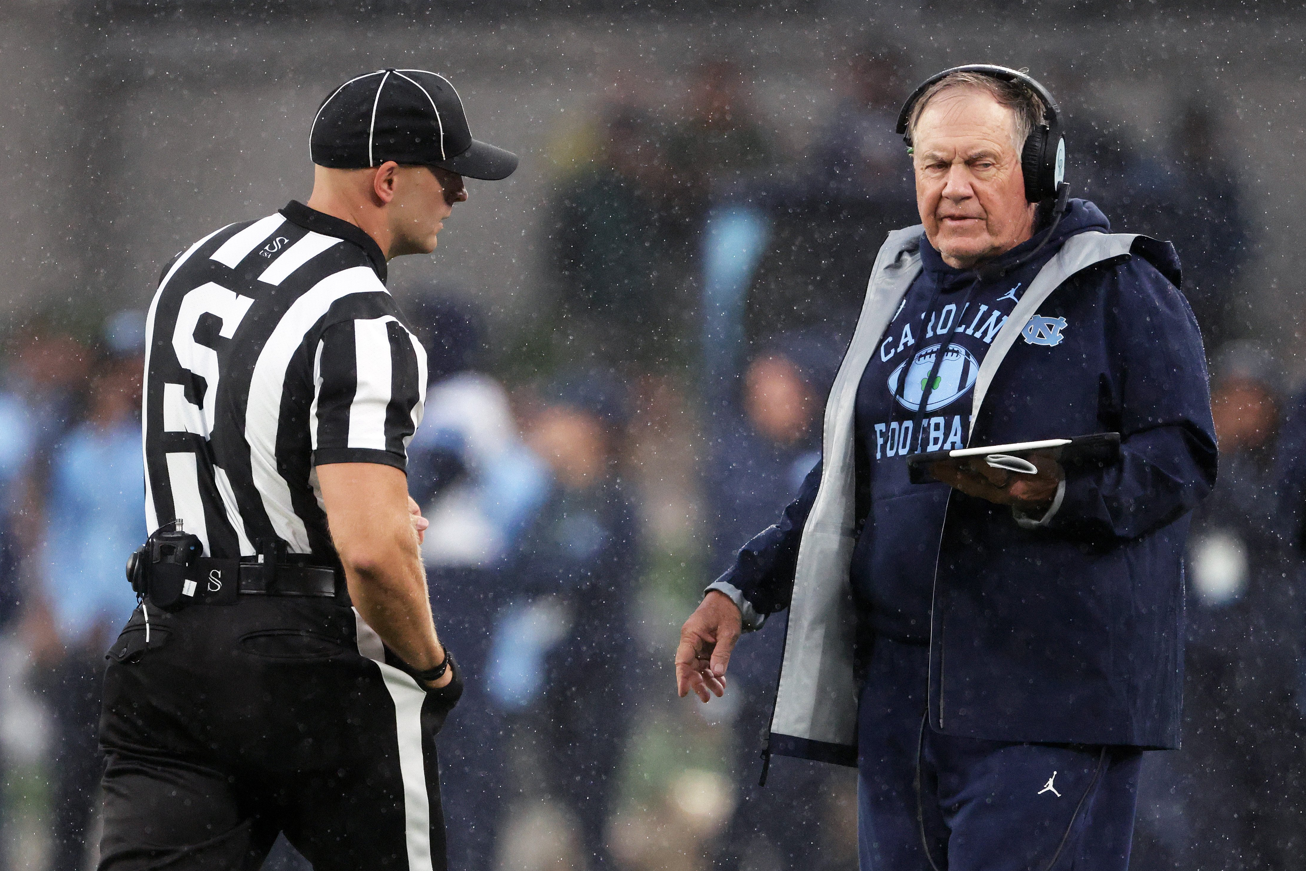 North Carolina head coach Bill Belichick, right, speaks with an official during an NCAA college football game against TCU in Dublin, Ireland, Saturday, Aug. 29, 2026. 