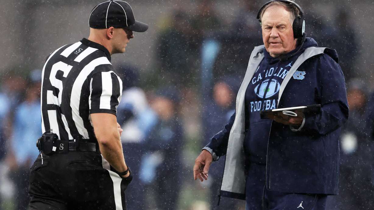 North Carolina head coach Bill Belichick, right, speaks with an official during an NCAA college football game against TCU in Dublin, Ireland, Saturday, Aug. 29, 2026.