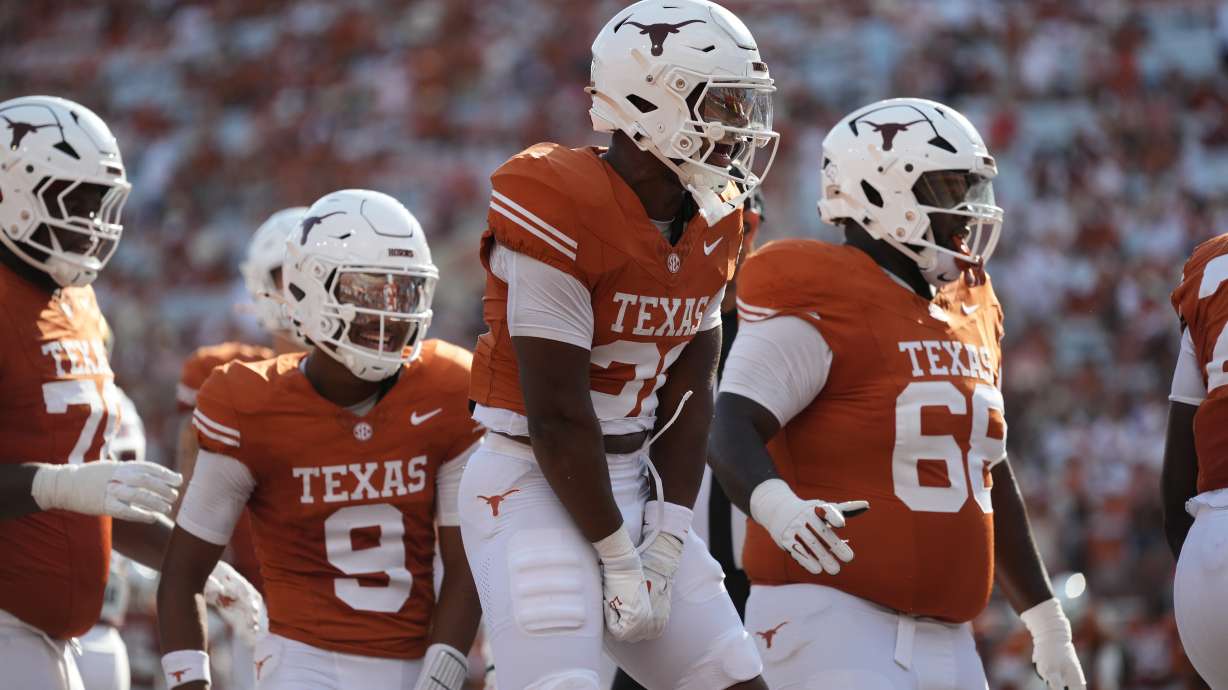 Texas running back James Simon (31) celebrates with teammates after scoring a touchdown against Texas State during the second half of an NCAA college football game in Austin, Texas, Saturday, Sept. 5, 2026.
