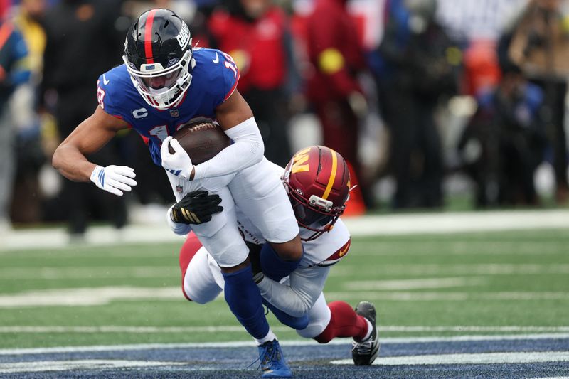Dec 14, 2025; East Rutherford, New Jersey, USA;  Washington Commanders safety Quan Martin (20) tackles New York Giants wide receiver Darius Slayton (18) during the first quarter at MetLife Stadium.