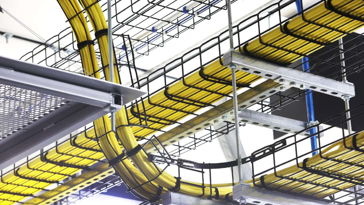 Numerous fiber optic cables hang at Meta’s Eagle Mountain Data Center on Sept. 30, 2022. The developer behind the world's largest data center campus in Millard County on Wednesday announced a project that aims to capture water vapor from natural gas combustion and convert it into usable water.