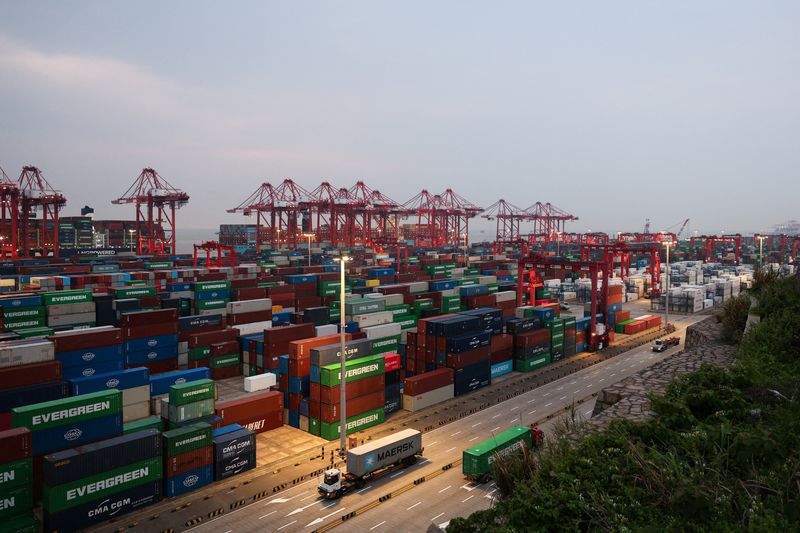 Gantry cranes stand near stacked shipping containers at Yangshan Port outside Shanghai, China, May 7, 2026.