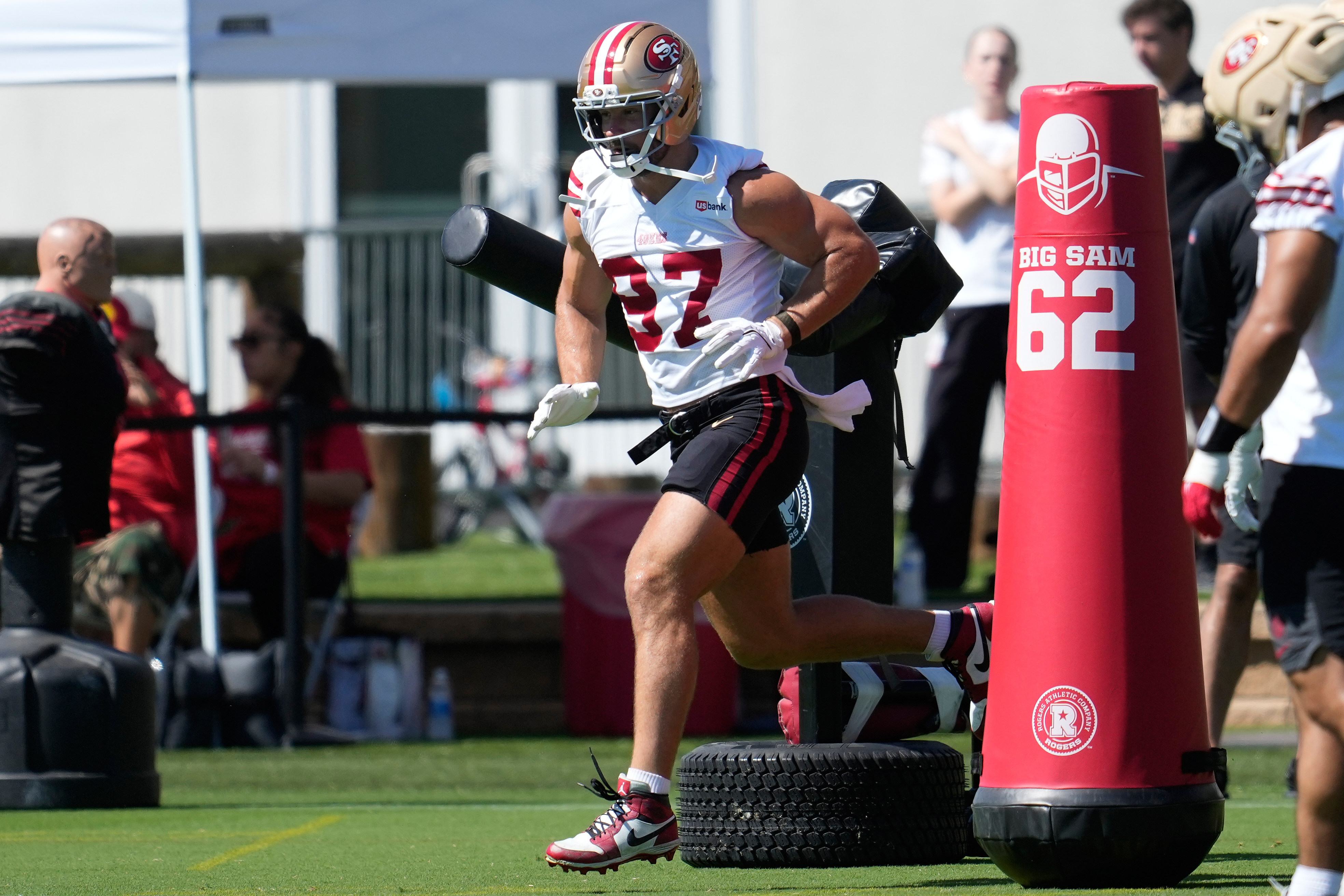 FILE - San Francisco 49ers defensive end Nick Bosa (97) runs a drill during the NFL football team's training camp, on July 27, 2026, in Santa Clara, Calif. 