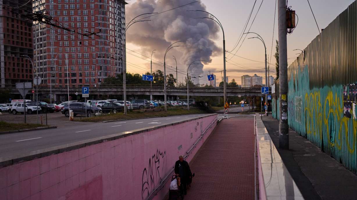 A man walks along an underpass as smoke rises following a Russian missile attack in Kyiv, Ukraine, early Tuesday. President Volodymyr Zelenskyy said U.S. envoys had "very good" ideas to end the war with Russia.