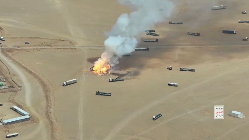 Smoke rises from a burning truck during what the Houthis say was an attack targeting trucks coming from Saudi territory, at Al-Wadiah border crossing near Al-Wadiah, on the Saudi-Yemen border, in this still image obtained from a handout video released Monday.