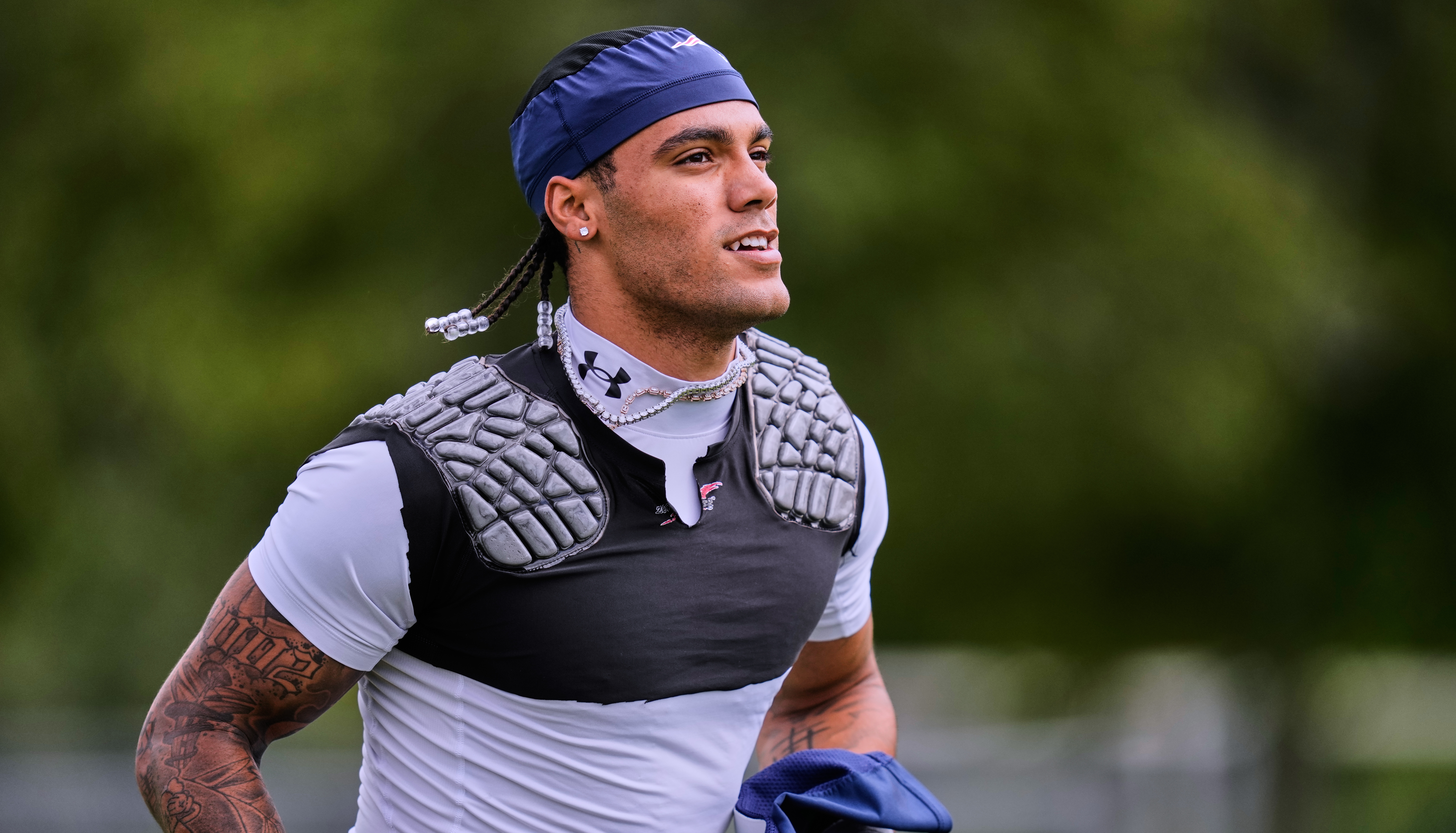 New England Patriots cornerback Christian Gonzalez runs towards a practice field during the team's NFL football training camp, Tuesday, Aug. 25, 2026, in Foxborough, Mass. 