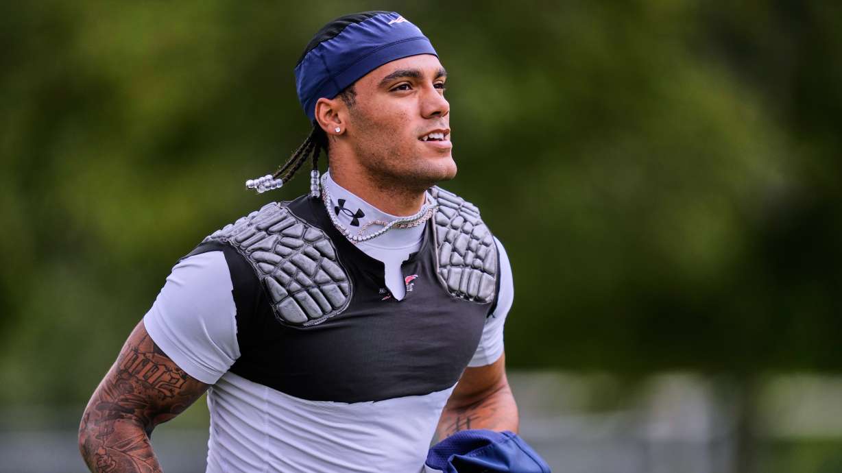 New England Patriots cornerback Christian Gonzalez runs towards a practice field during the team's NFL football training camp, Tuesday, Aug. 25, 2026, in Foxborough, Mass.