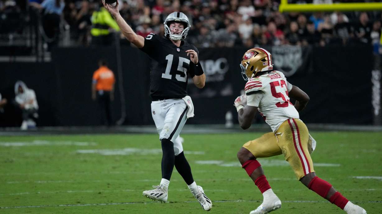 Las Vegas Raiders quarterback Fernando Mendoza (15) throws under pressure from San Francisco 49ers linebacker Jaden Dugger (53) during the second half of an NFL preseason football game, Thursday, Aug. 27, 2026, in Las Vegas.