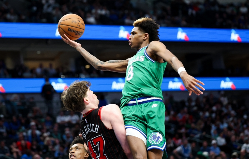 Apr 12, 2026; Dallas, Texas, USA;  Dallas Mavericks guard AJ Johnson (8) drives to the basket as Chicago Bulls center Lachlan Olbrich (47) defends during the second half at American Airlines Center.