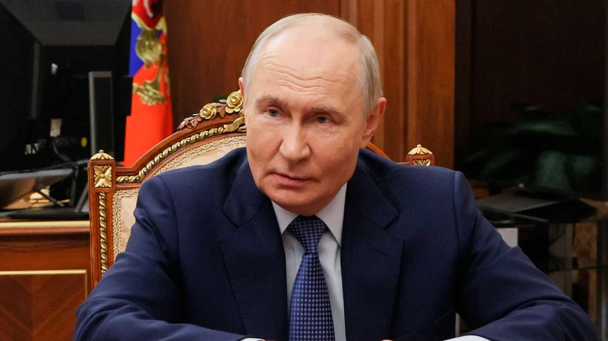 Russian President Vladimir Putin listens to acting Governor of Tver region Vitaly Korolyov during their meeting at the Kremlin in Moscow, Tuesday. Putin assured President Donald Trump that Russia had no aggressive plans toward Europe.