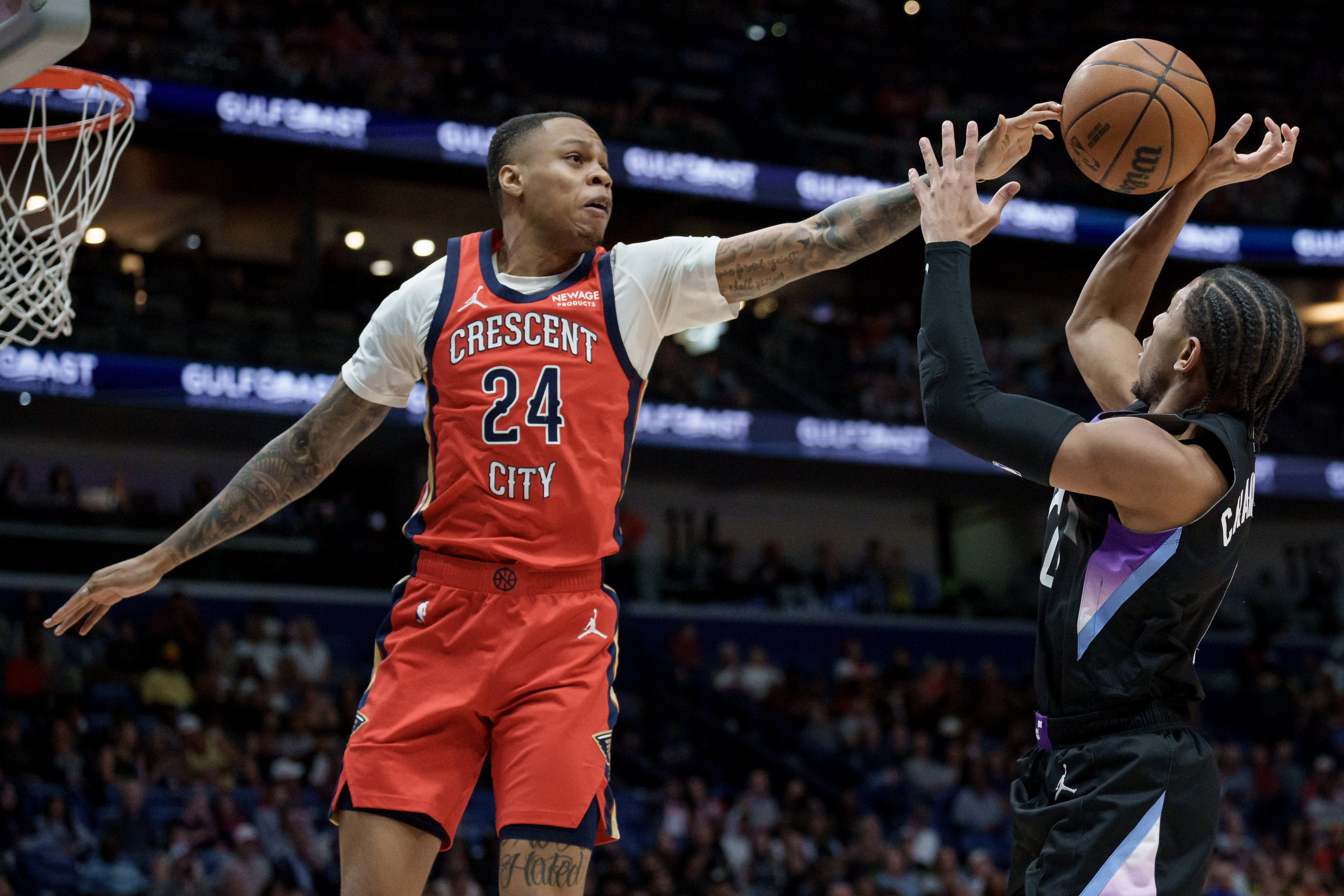 FILE - New Orleans Pelicans guard Jordan Hawkins (24) blocks the shot of Utah Jazz guard Kennedy Chandler (0) during the first half of an NBA basketball game in New Orleans, April 7, 2026. 
