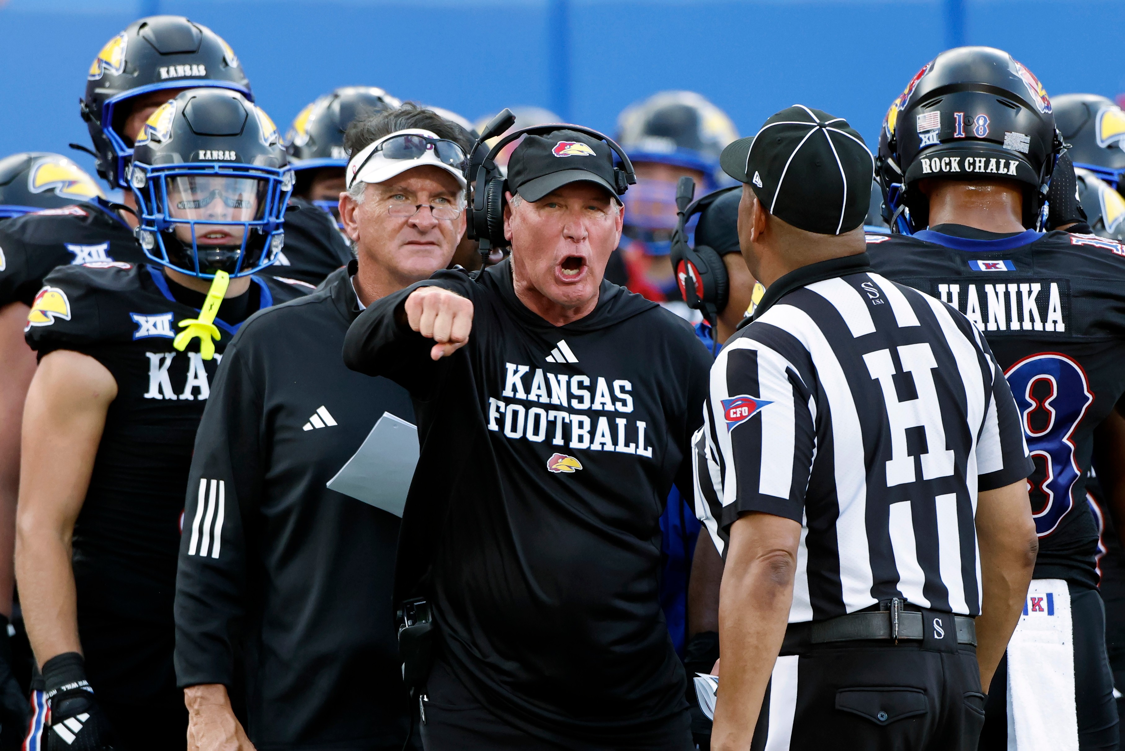 FILE - Kansas head coach Lance Leipold, center, disputes a call by an official during the first half of an NCAA collage football game against West Virginia Sept. 20, 2025, in Lawrence, Kan. 