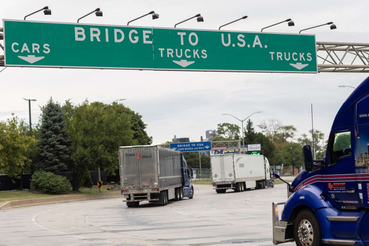 Transport trucks cross the Ambassador Bridge into the United States of America, in Windsor, Ontario, Canada, Aug. 22. U.S.-Canada relations continue to sour as Washington announced a ban on certain Canadian products on Wednesday.