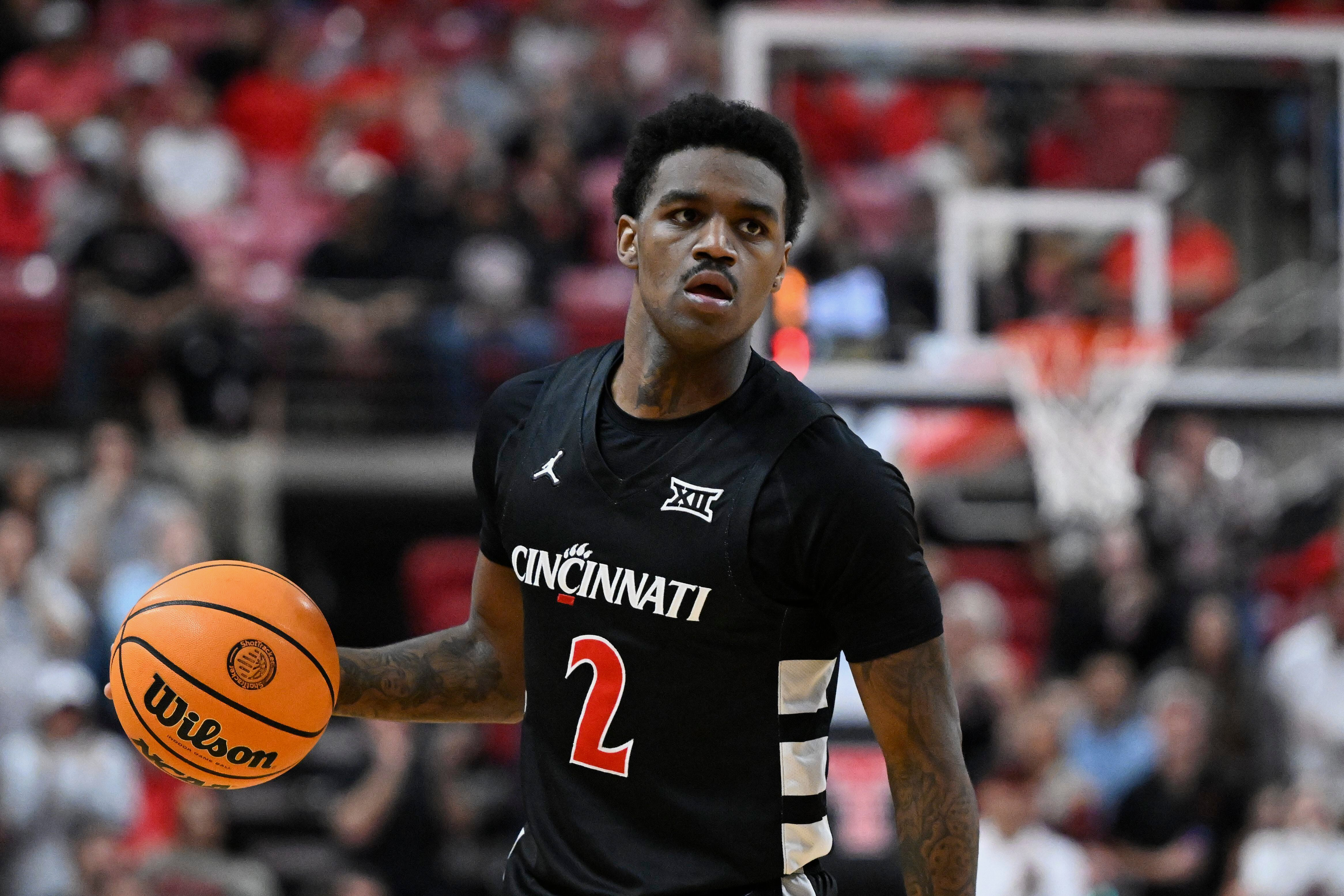 FILE - Cincinnati guard Jizzle James (2) brings the ball up court against Texas Tech during the second half of an NCAA college basketball game on Feb. 24, 2026, in Lubbock, Texas. 