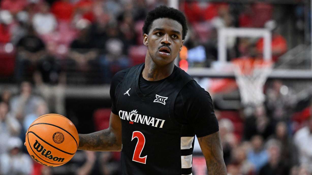FILE - Cincinnati guard Jizzle James (2) brings the ball up court against Texas Tech during the second half of an NCAA college basketball game on Feb. 24, 2026, in Lubbock, Texas.