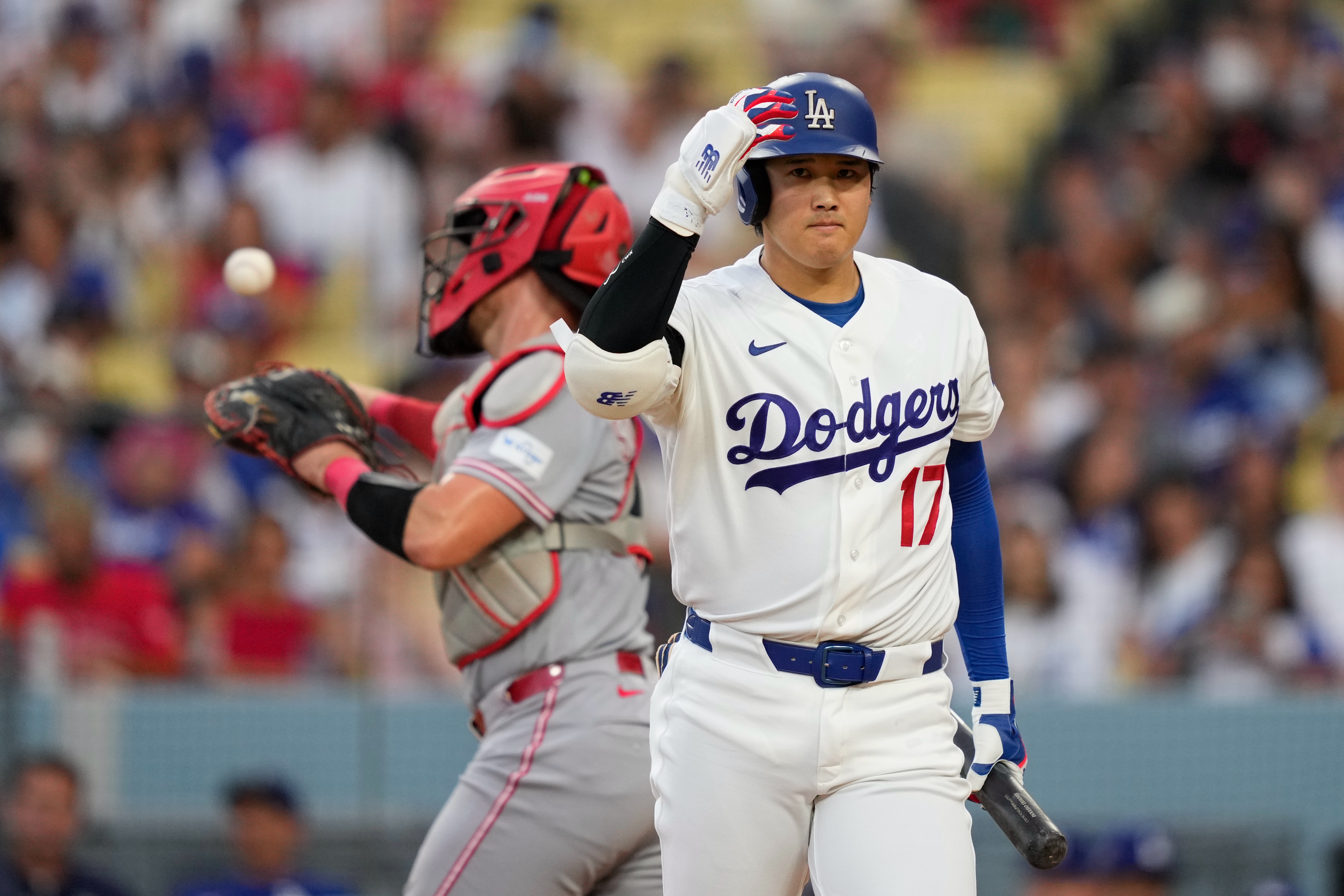 Los Angeles Dodgers' Shohei Ohtani, right, walks back to the dugout after striking out as Cincinnati Reds catcher Tyler Stephenson throws the ball back during the third inning of a baseball game Monday, Sept. 7, 2026, in Los Angeles. 