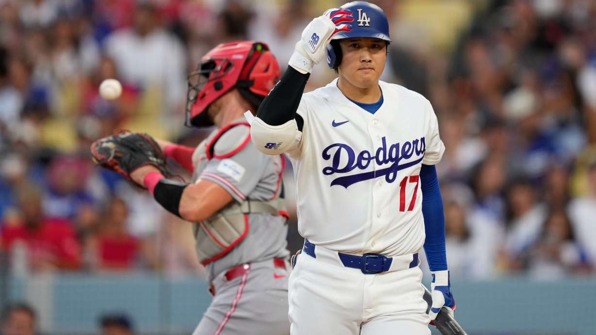 Los Angeles Dodgers' Shohei Ohtani, right, walks back to the dugout after striking out as Cincinnati Reds catcher Tyler Stephenson throws the ball back during the third inning of a baseball game Monday, Sept. 7, 2026, in Los Angeles.