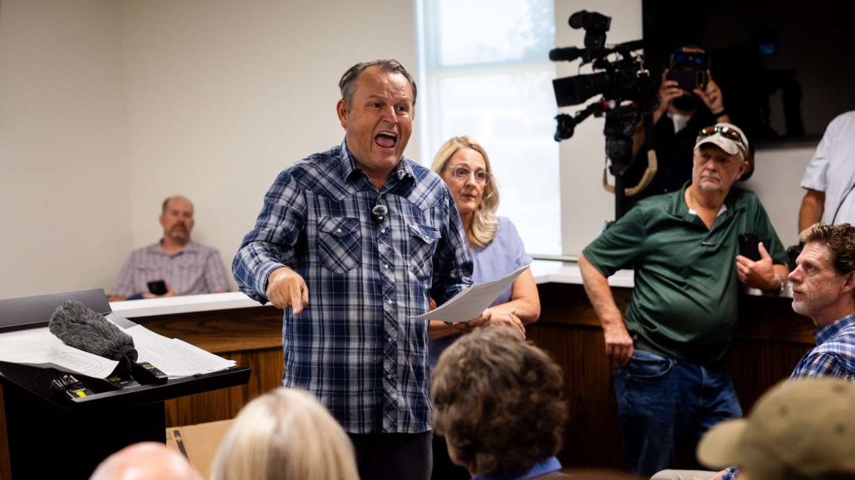 Taylor Flake protests the proposed data center just outside of Mona during the public comment portion of the Juab County Commission meeting at Rocky Ridge Town Hall in Rocky Ridge on Tuesday.