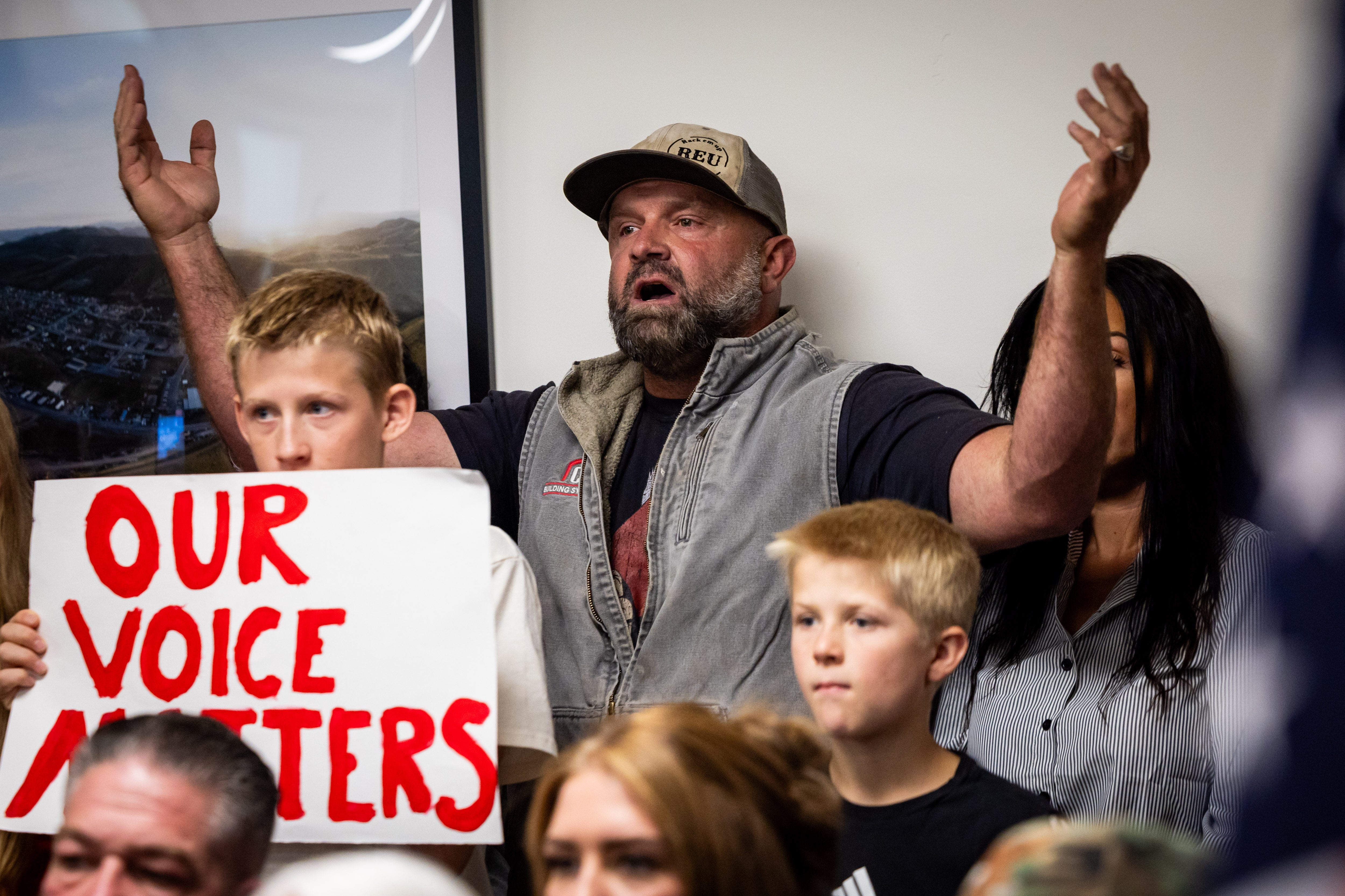 Mark Martineau, center, who has a farm in Mona, and others protest the proposed data center just outside of Mona during the public comment portion of the Juab County Commission meeting at Rocky Ridge Town Hall in Rocky Ridge on Tuesday.