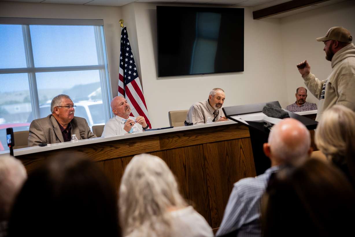 Commissioner Marty Palmer, commission Chairman Clinton Painter, and commissioner Marvin Kenison, from left, listen as Dan Woodland, from Mona, right, speaks out against the proposed data center just outside of Mona, even though he says he is not “anti-data center,” during the public comment portion of the Juab County Commission meeting at Rocky Ridge Town Hall in Rocky Ridge on Tuesday.