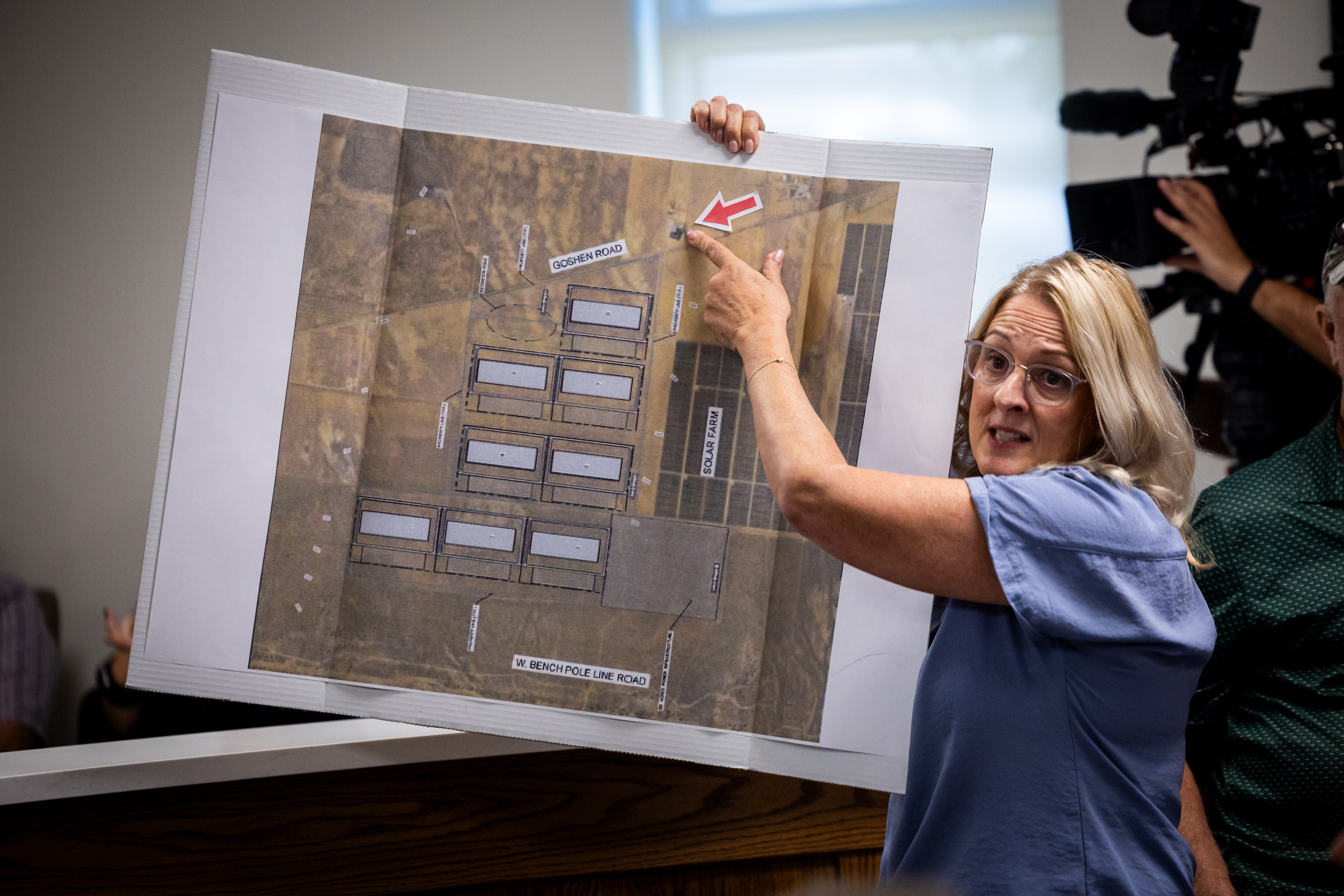 Shelley Flake shows where her ranch is located, across the street from the proposed data center, as she protests the proposed data center just outside of Mona during the public comment portion of the Juab County Commission meeting at Rocky Ridge Town Hall in Rocky Ridge on Tuesday.