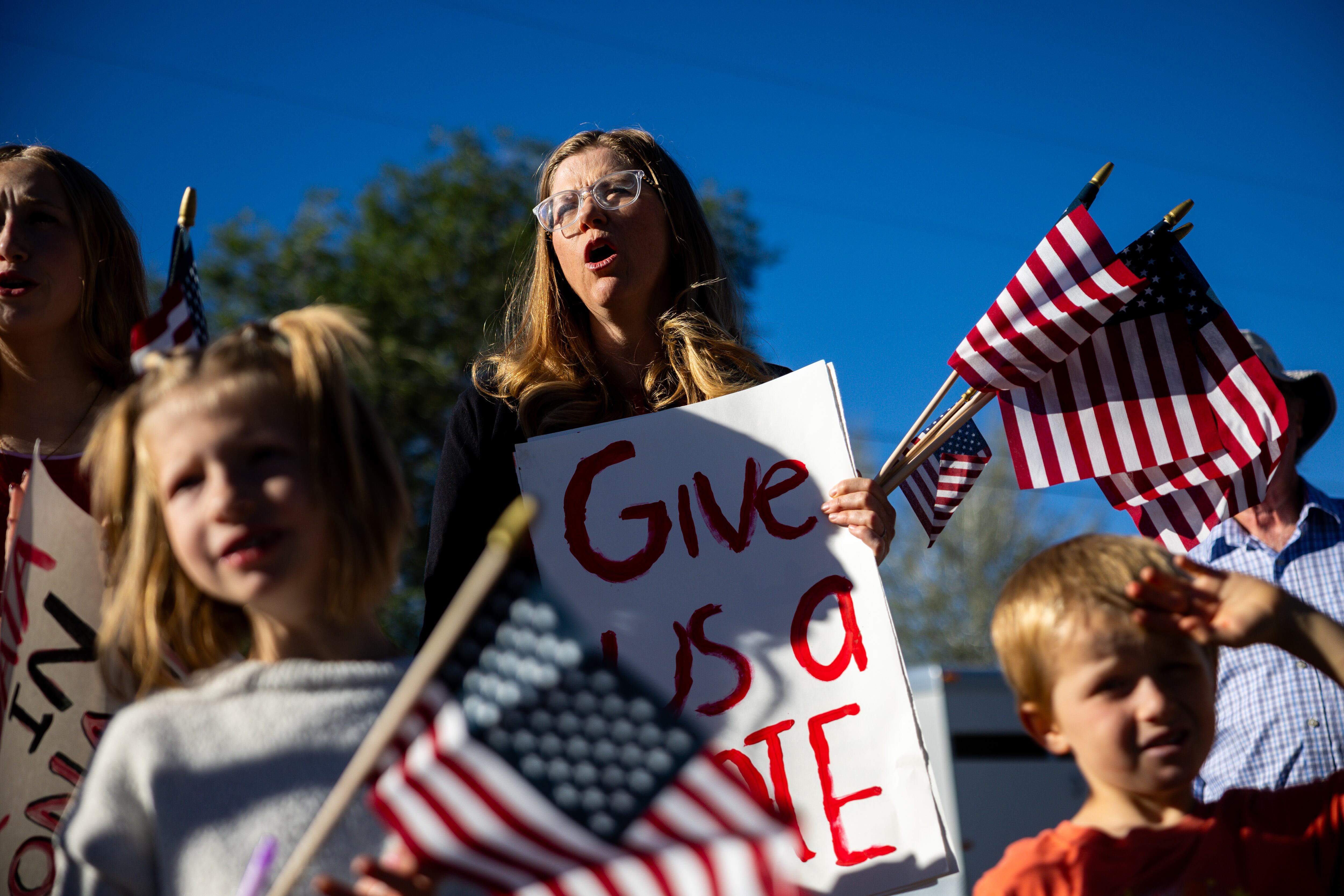 Cherise Cooper, who has lived in Mona for eight years with her family, center, gathers outside the Mona City Center before leaving to protest the proposed data center just outside of Mona during the public comment portion of the Juab County Commission meeting at Rocky Ridge Town Hall in Rocky Ridge on Tuesday.