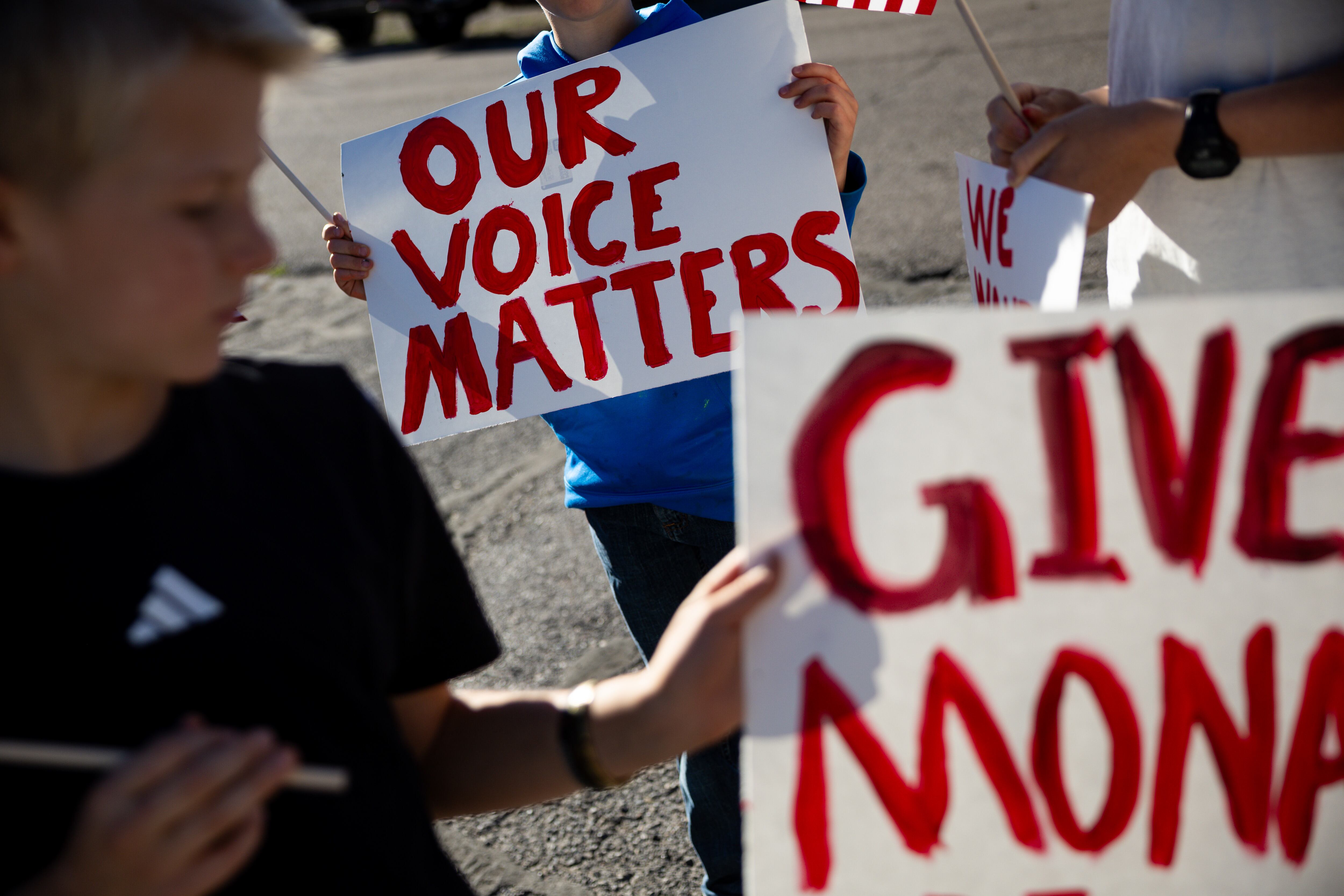 The Cooper family, who has lived in Mona for eight years, gathers with signs outside the Mona City Center before leaving to protest the proposed data center just outside of Mona during the public comment portion of the Juab County Commission meeting at Rocky Ridge Town Hall in Rocky Ridge on Tuesday.