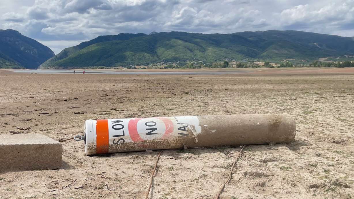 With Pineview Reservoir in Weber County emptying, plans to install a replacement section of pipeline across the bed of the lake are expected to move forward next week. A buoy in a portion of the drained lake bed is pictured on Sunday.