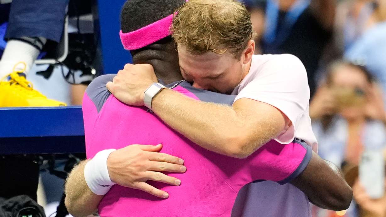 Frances Tiafoe, left, of the United States, and Alex Michelsen, of the United States, embrace after Tiafoe won their match in the quarterfinal round of the U.S. Open tennis championships, Tuesday, Sept. 8, 2026, in New York. CORRECTION: Corrects Tiafoe to left, not right.