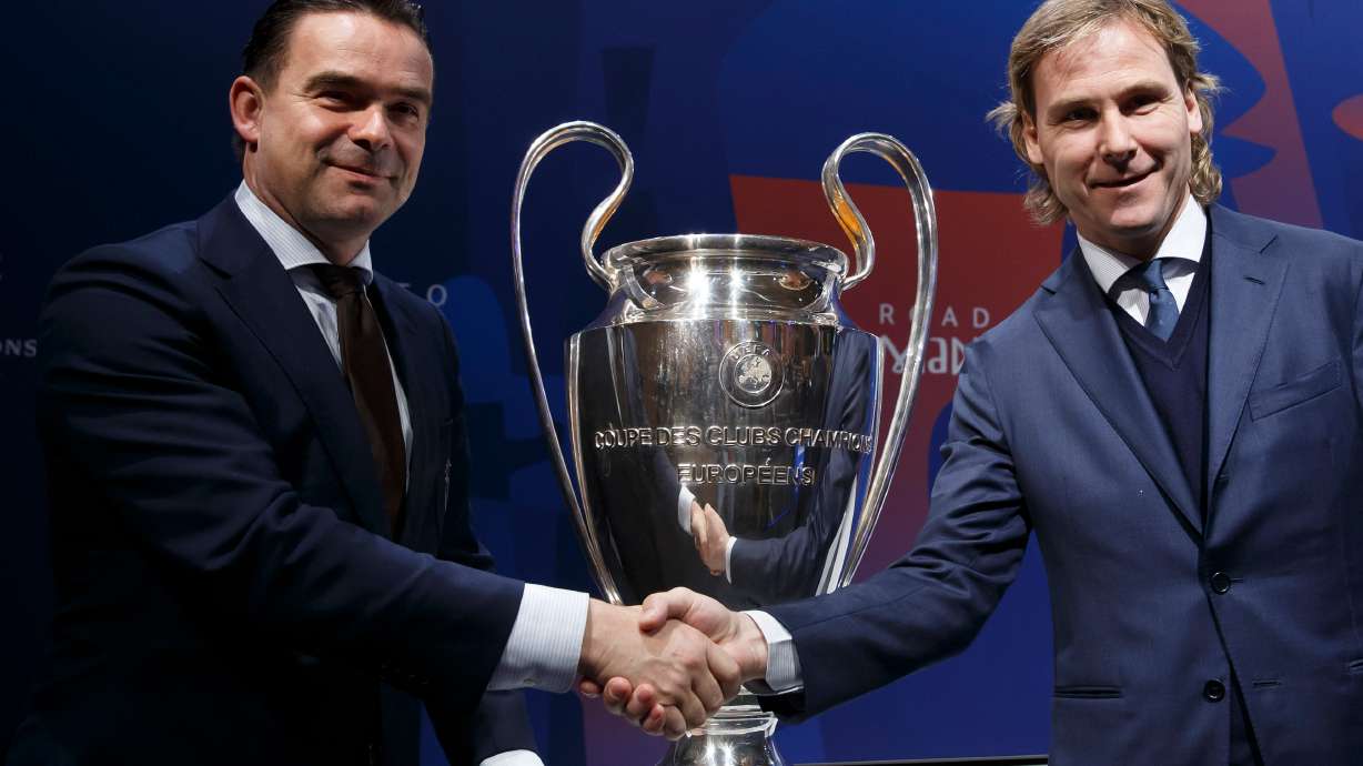 FILE - Marc Overmars, left, shakes hands with Pavel Nedved at the UEFA headquarters in Nyon, Switzerland, Friday, March 15, 2019.