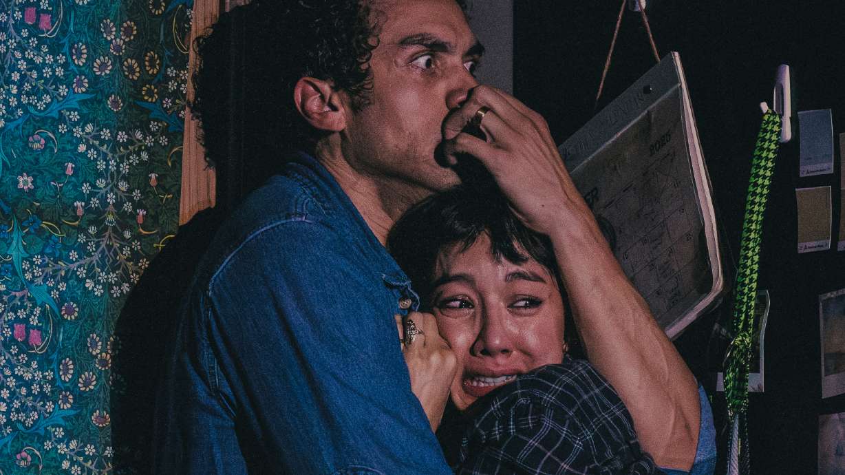 Travis A. Knight, left, and Cher Álvarez appear during a performance of the play "Paranormal Activity" in Boston on July 10.