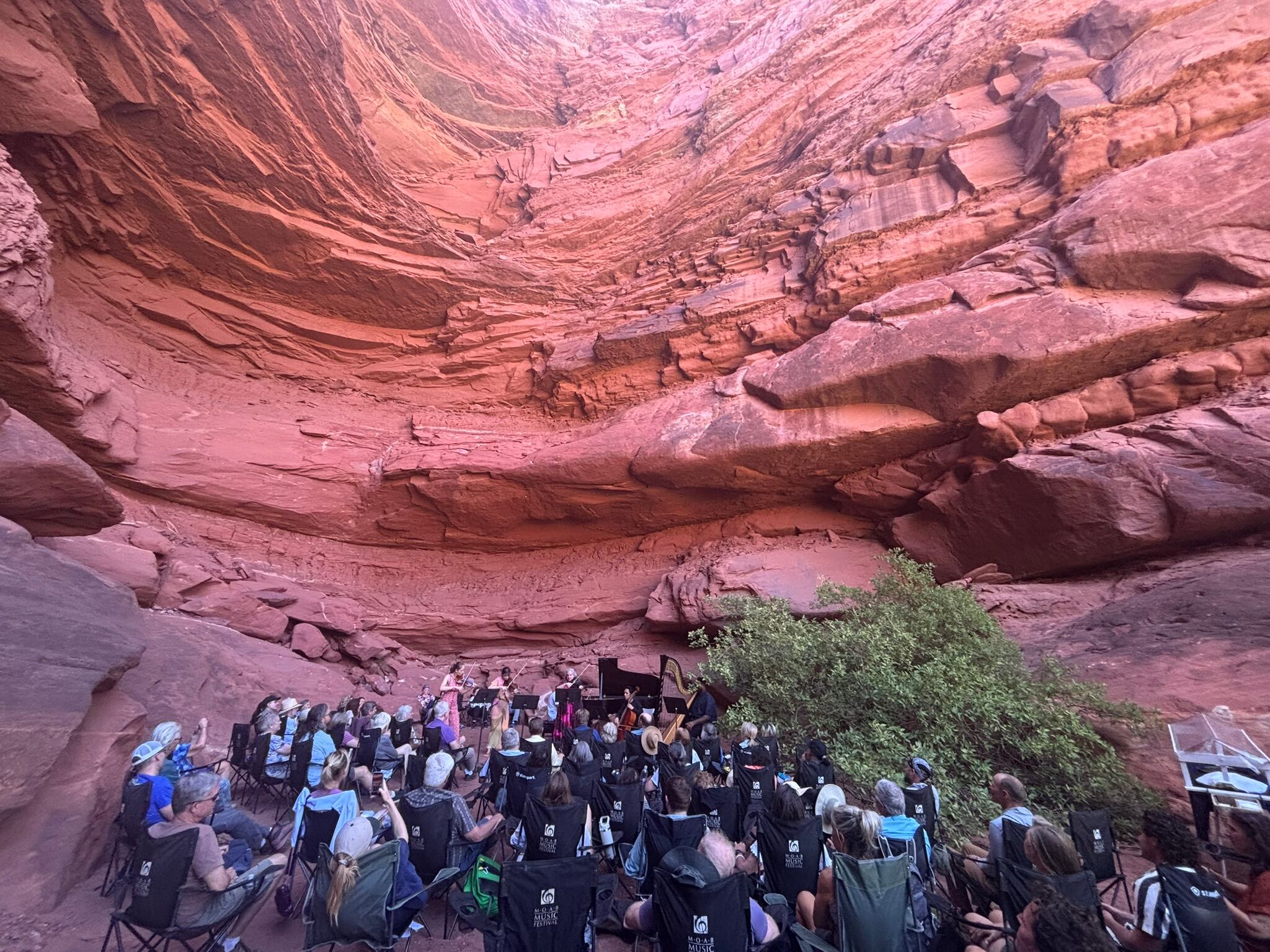 Guests attend the "Grotto I: Fantasy" program of the Moab Music Festival on Sept. 3, in Canyonlands National Park. Musicians, from left to right, are Geneva Lewis on violin, Tessa Lark on violin, Peter Dugan on piano, Beth Guterman Chu on viola and Jay Campbell on cello.