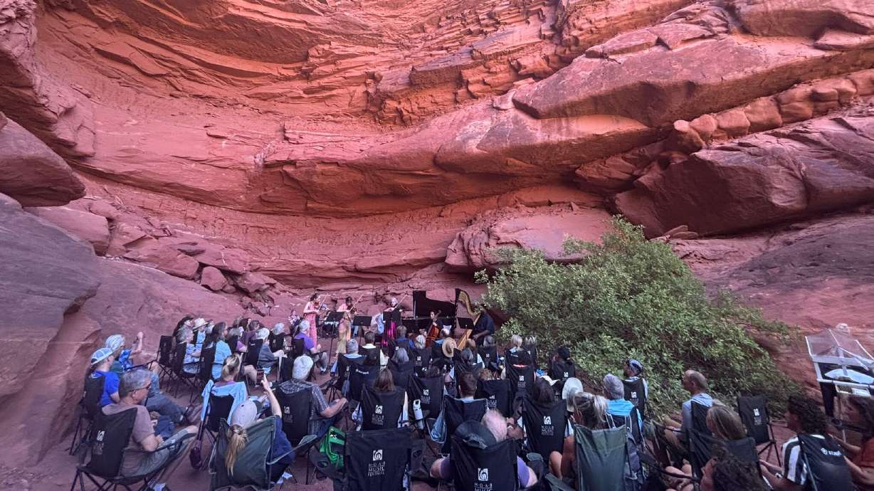 Guests attend the "Grotto I: Fantasy" program of the Moab Music Festival on Sept. 3, in Canyonlands National Park. Musicians, from left to right, are Geneva Lewis on violin, Tessa Lark on violin, Peter Dugan on piano, Beth Guterman Chu on viola and Jay Campbell on cello.