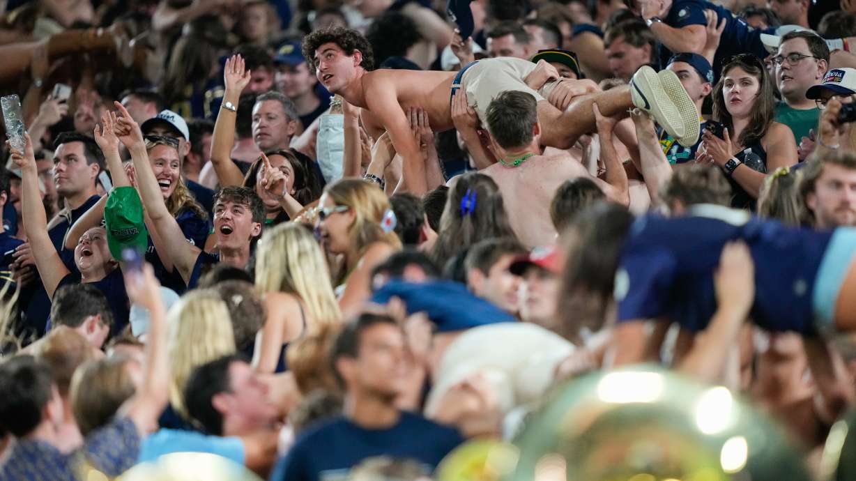 Notre Dame fans celebrate scoring a touchdown with pushups during the second half of an NCAA college football game against Wisconsin Sunday, Sept. 6, 2026, in Green Bay, Wis.